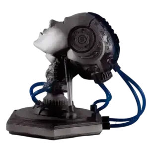 The image shows a handmade art sculpture titled “Theta,” created by artist Freaky Deek. The sculpture depicts a futuristic android with a sleek, metallic design. Blue LED lights illuminate various parts of the android’s body, especially its head and chest, giving the figure a glowing, ethereal appearance. The intricate details and smooth surfaces of the sculpture are enhanced by the vibrant blue lighting, standing out against the plain background.